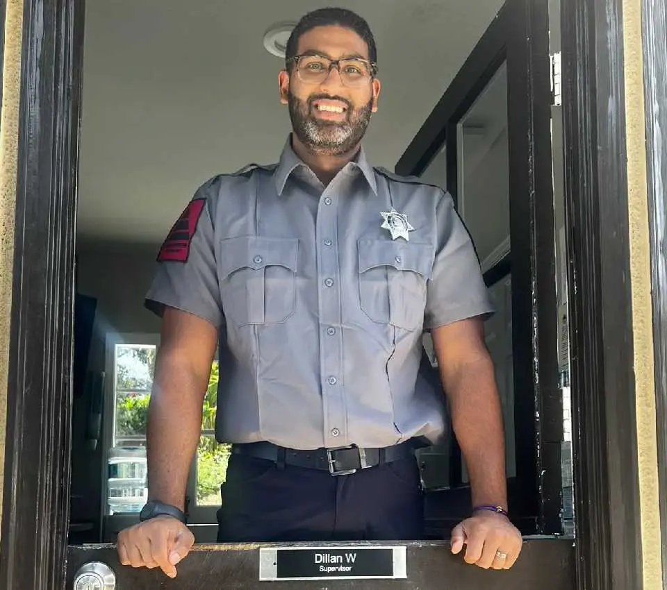 A man in uniform standing inside of a door way.